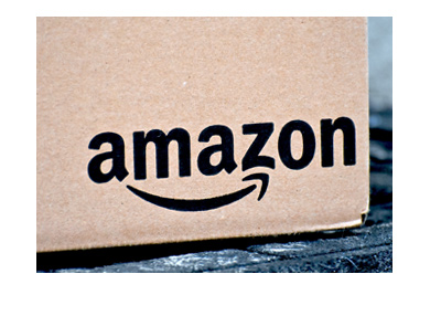 Amazon shipping. Parcel is delivered and waiting on the doorstep. Closeup.