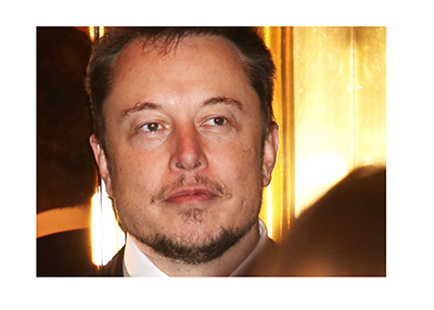 Elon Musk photographed in the crowd.  Exiting an elevator.