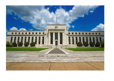 The Federal Reserve Building on a day with mixed cloud and sunshine