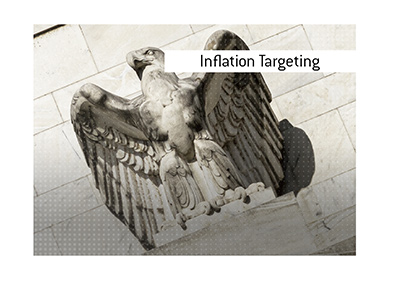 The meaning and definition of the economic term Inflation Targeting is explained.  What is it?  In photo:  Federal Reserve building eagle closeup.