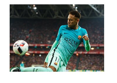Neymar, wearing the barca away shirt, is showing skills with the ball. Transfer to PSG is pending.