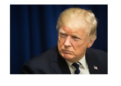 The United States president - Donald Trump - Patiently listening in his trademark pose. Year is 2017.