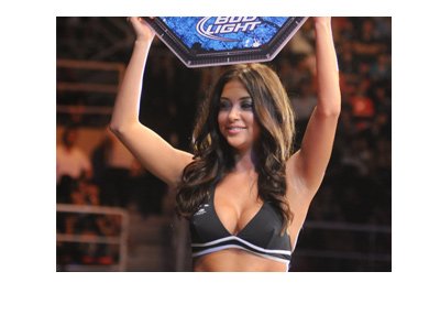 The beautiful UFC Octagon Girl holding up a round sign.