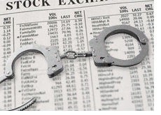 handcuffs on top of a stock market data chart