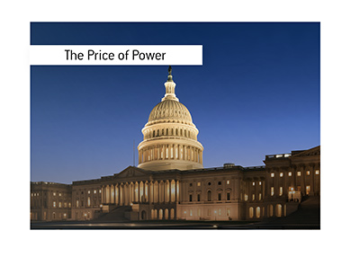 The U.S. Capitol at dusk, with both wings visible. The illuminated building against a deep blue sky.